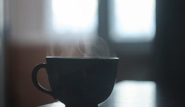 black ceramic cup with smoke above