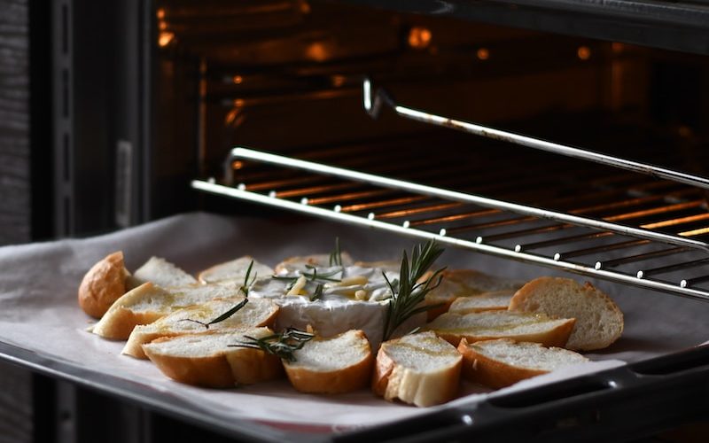 bread with meat on black tray