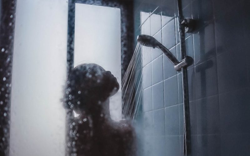 woman under showerhead