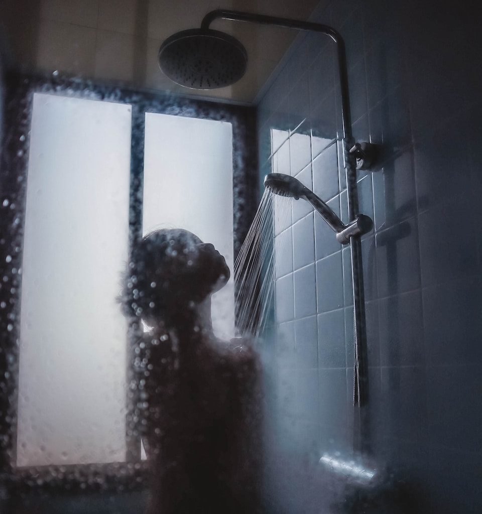 woman under showerhead