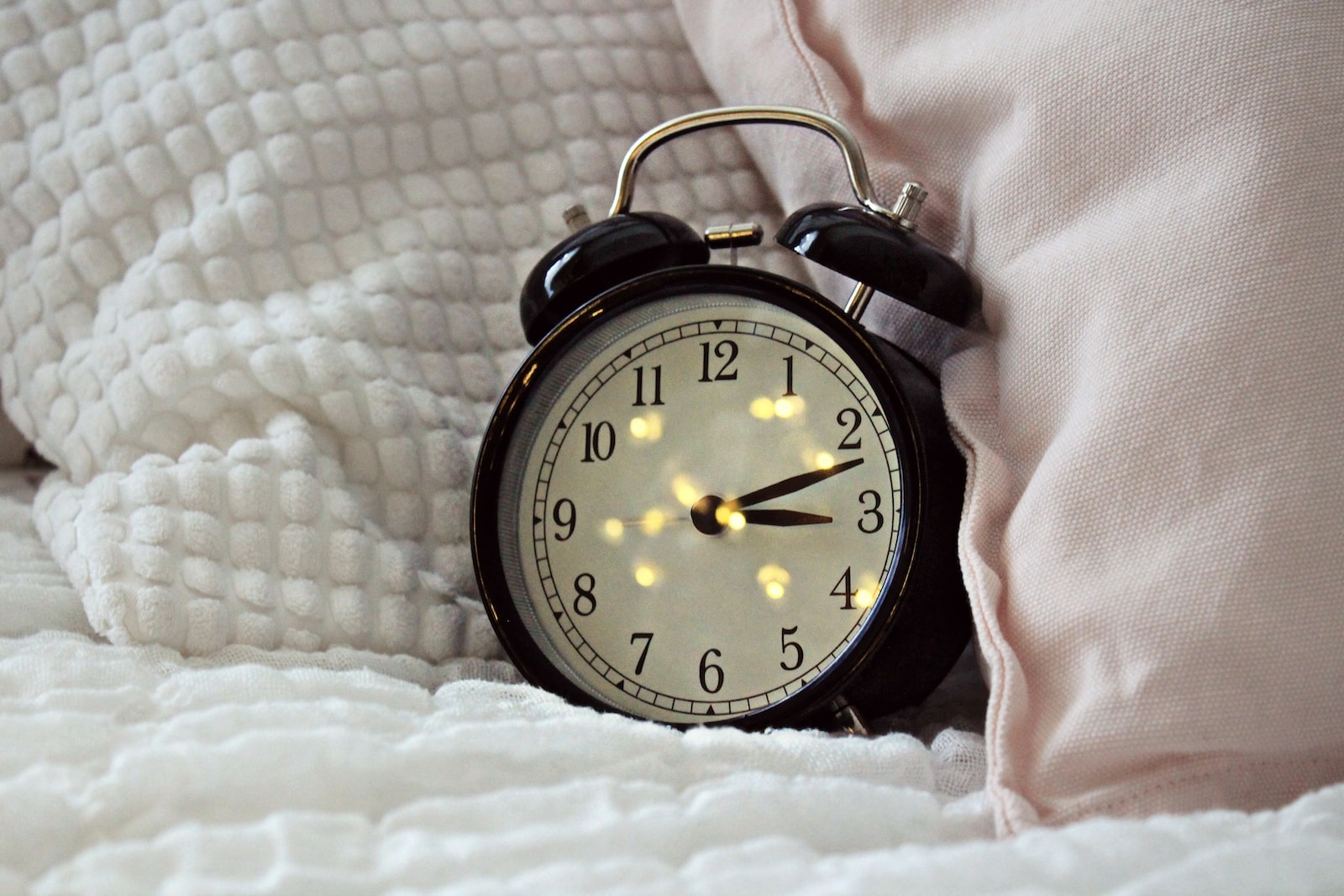 round black alarm clock displaying 3:12