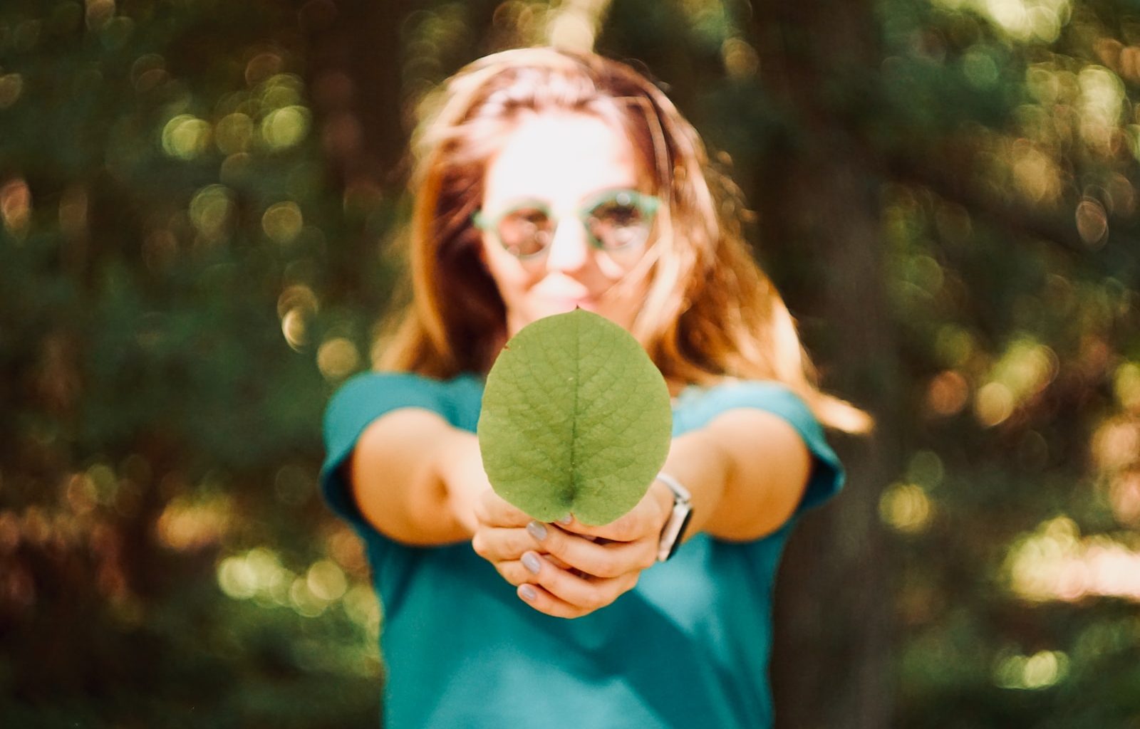 woman holding leaf