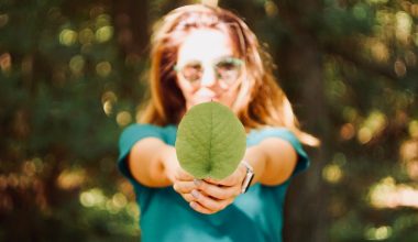 woman holding leaf