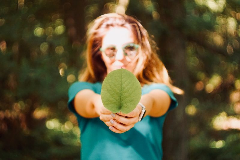 woman holding leaf