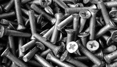 silver screw lot on brown wooden table