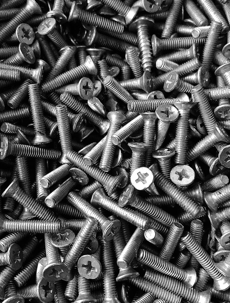 silver screw lot on brown wooden table