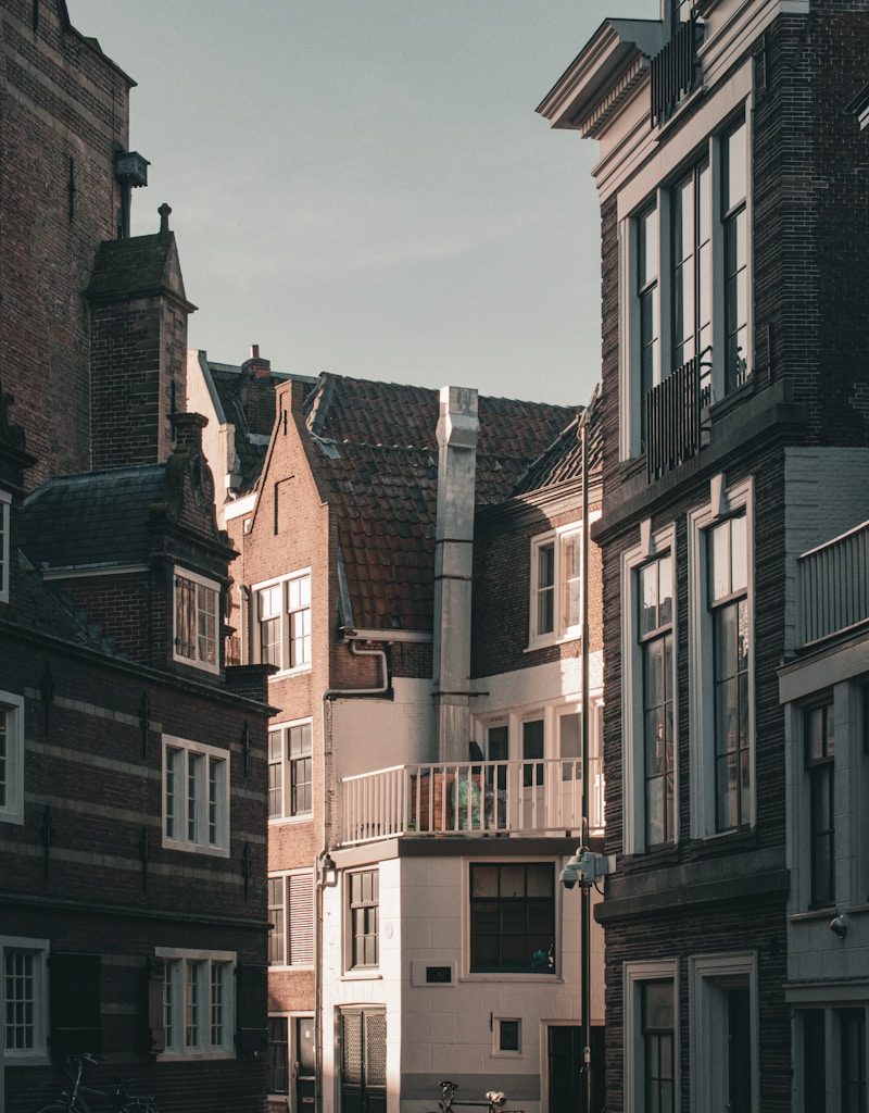 a row of buildings with bicycles parked in front of them