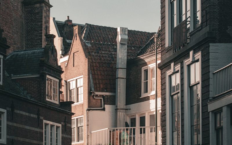 a row of buildings with bicycles parked in front of them