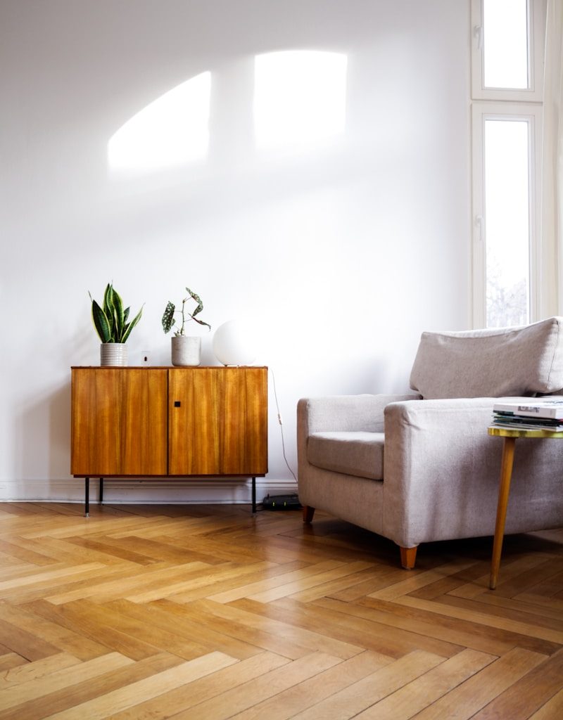 brown wooden table beside gray couch