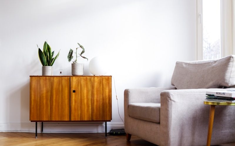 brown wooden table beside gray couch