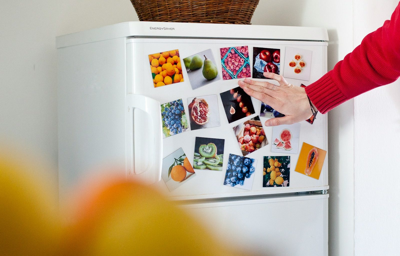 a refrigerator with pictures of fruits and vegetables on it