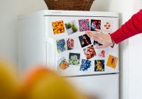 a refrigerator with pictures of fruits and vegetables on it